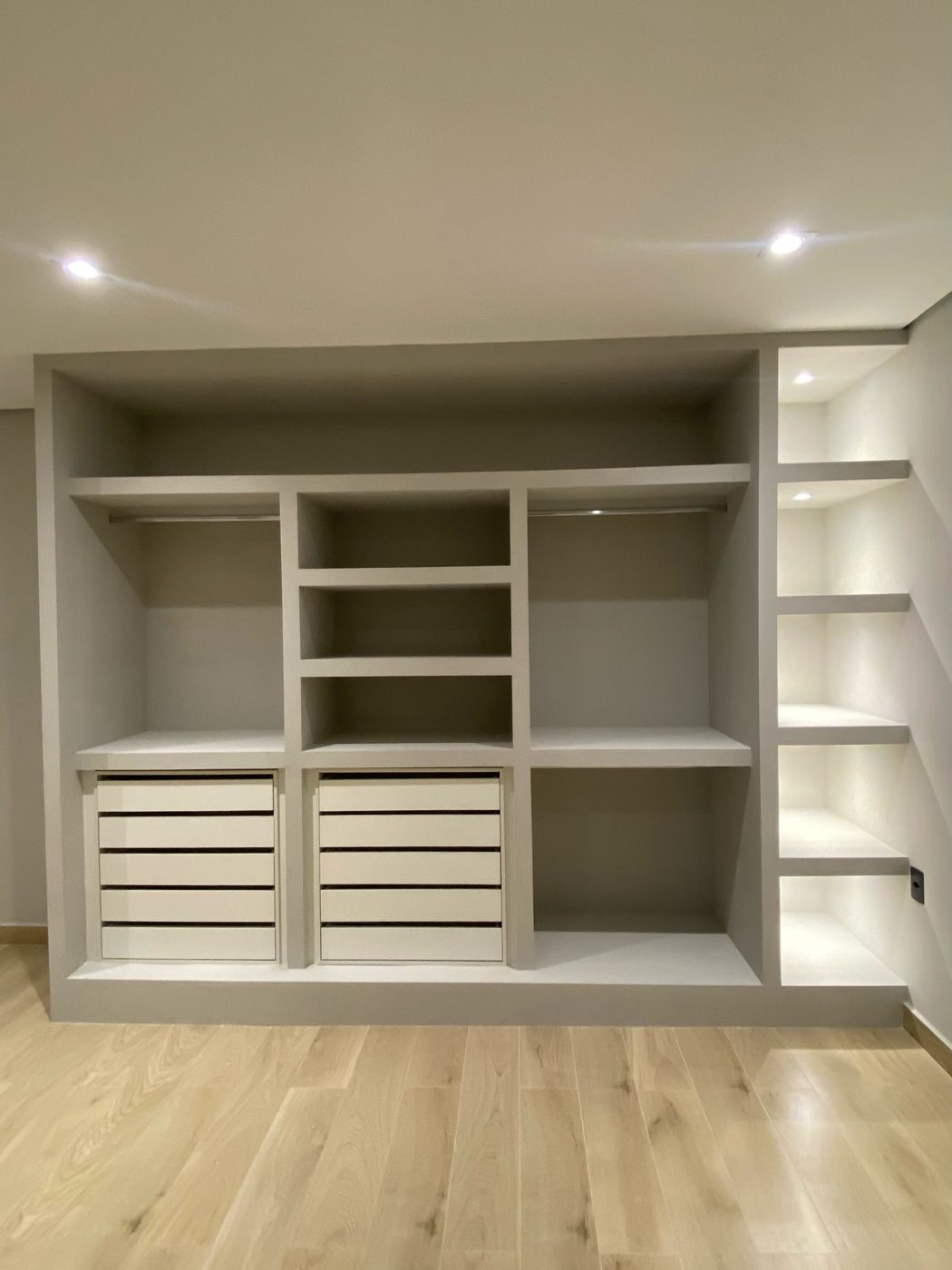 Closet planejado com prateleiras, gavetas e iluminação